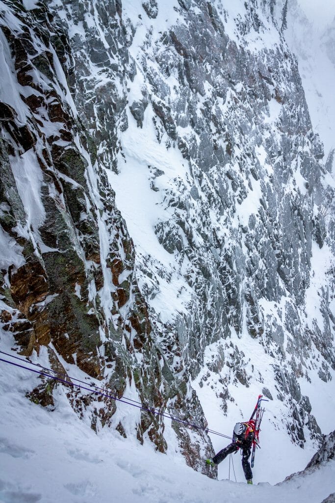 Ian Johnston rappels over a cliff in the Tetons