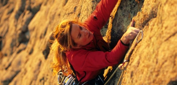 Carolyn Parker climbing a cliff