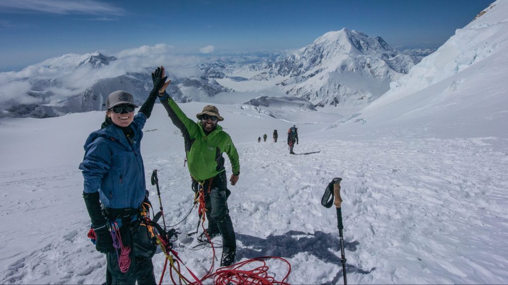 Climbers high-fiving during an ascend