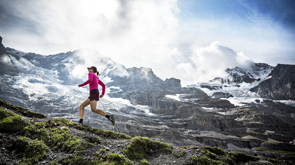 female athlete Trail running in the Swiss Alps