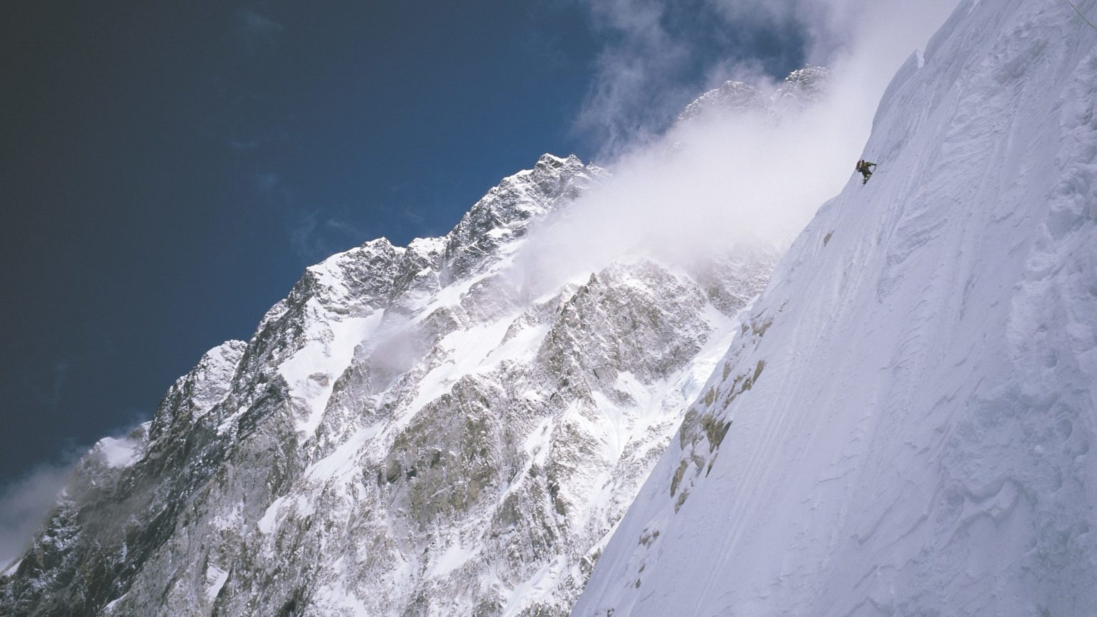 Alpinist climbing a mountain side