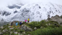 a group of mountain runners heading toward a snowy mountain