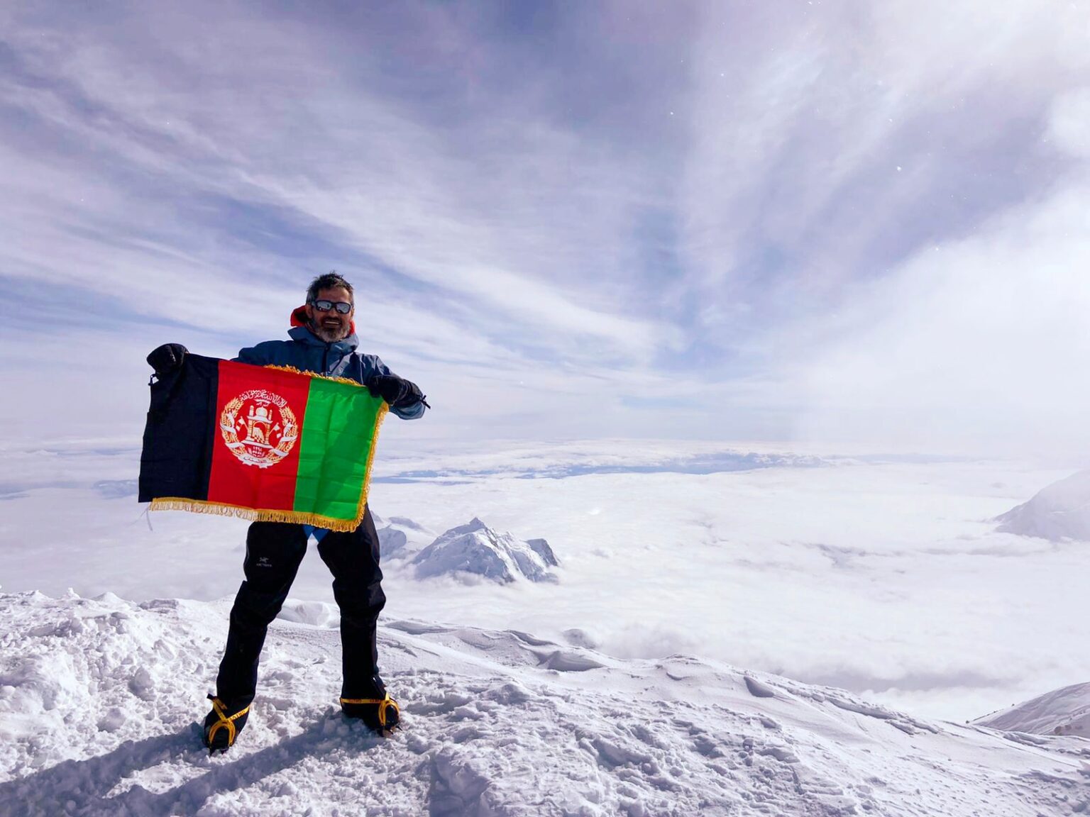 Sam displays the Afghan flag for the first time at the highest point in North America.