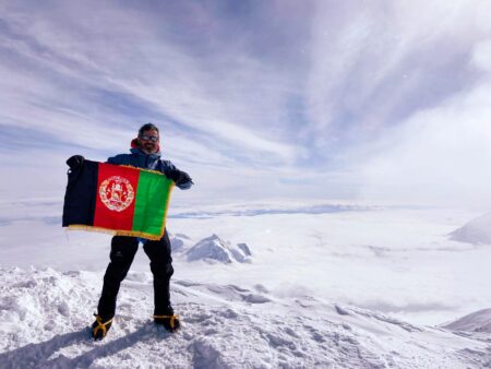 Sam displays the Afghan flag for the first time at the highest point in North America.