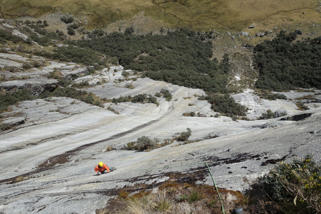 A rock climber climbing a wall in Peru, image taken from above.