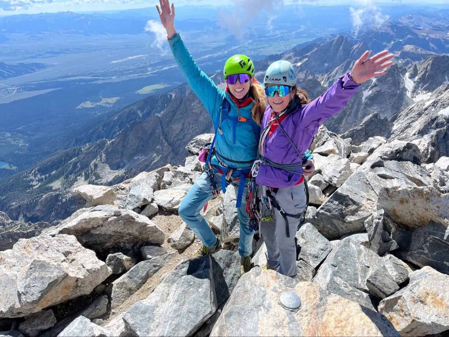 Two women climbers on a rocky mountain summit