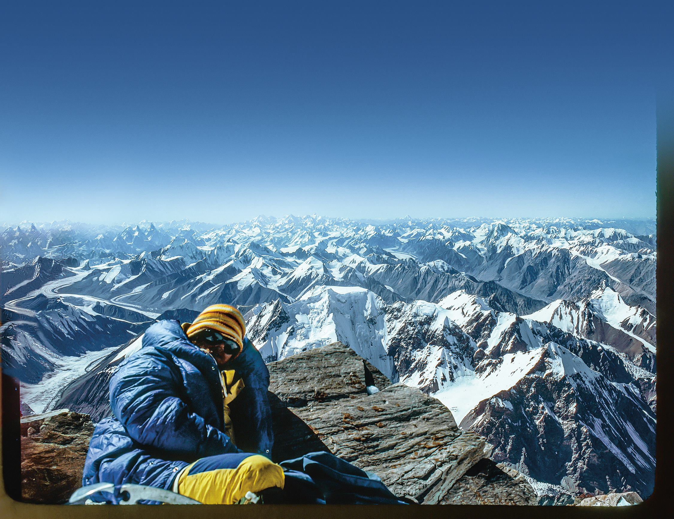 Rick Ridgeway Resting on Summit K2 by John Roskelley Med Res enhanced
