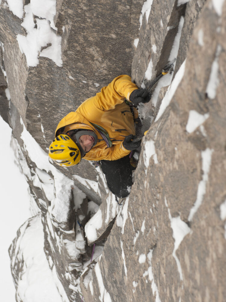 A male ice climber climbing the Ames Ice Hose,(WI5, M6) Ames, Colorado, USA A male ice climber climbing the Ames Ice Hose,(WI5, M6) Ames, Colorado, USA