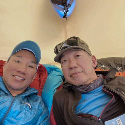 A traditional alpine-trip selfie inside the tent, with Ishidera on the left and Mori on the right.