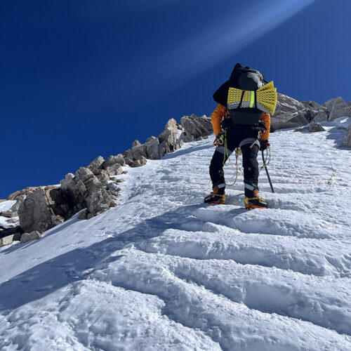 Mori-San moving up to high camp on a spectacular section of the West Buttress under cloudless skies. Because of the excellent weather, the route saw lots of travel, leading to these perfectly cut steps. “We loved this section, but certainly it was the toughest part of the climb,” says Ishidera.